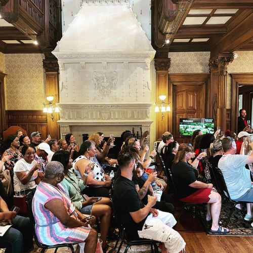 A crowd seated inside Rathalla for an admissions event to represent how admissions is part of why Rosemont College is a Forbes rated best online college, and a best mainline college.