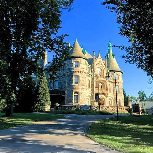 Rosemont College Main Building Rathalla framed by summer trees against a blue sky that is part of why Rosemont College is Forbes rated best online college, and a best mainline college.