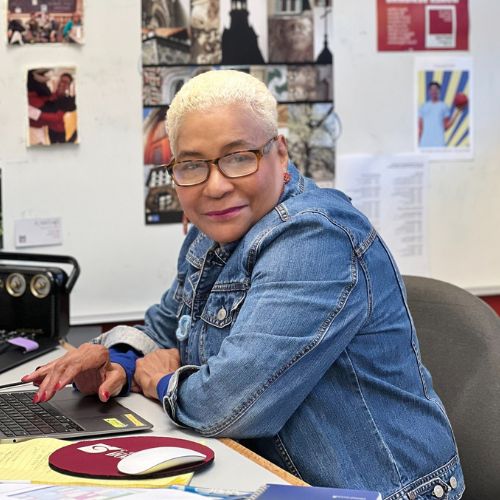Close up of Joan Wilder working at her office desk to represent how Adjunct Instructors are part of why Rosemont College is a Forbes rated best online college, and a best Main Line college.