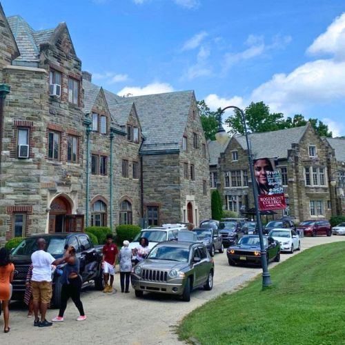 Students and parents creating traffic in front of the dorms on move in day to represent how