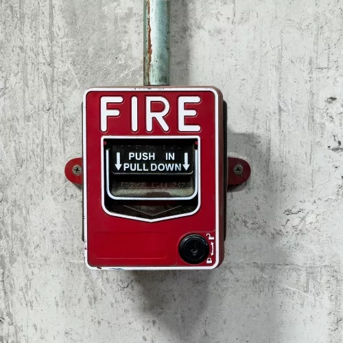 A close up of a fire alarm to represent how employees are part of why Rosemont College is a Forbes rated best online college, and a best Main Line college.