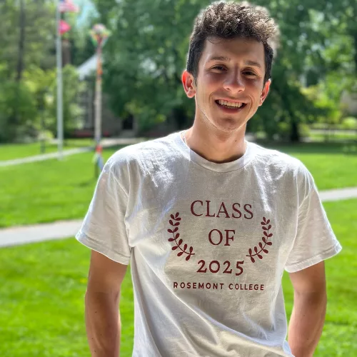Student Dominic Younger on the porch of Main Building represent part of why Rosemont College is a Forbes rated best online college, and a best Main Line college.
