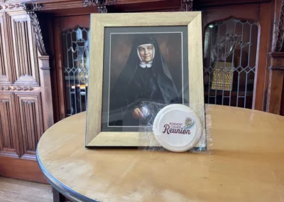 Reunion cookie in front of a photo of Cornelia Connelly in the main building Rathalla to represent how Rosemont College is a Forbes rated best online college, and a best Main Line college.