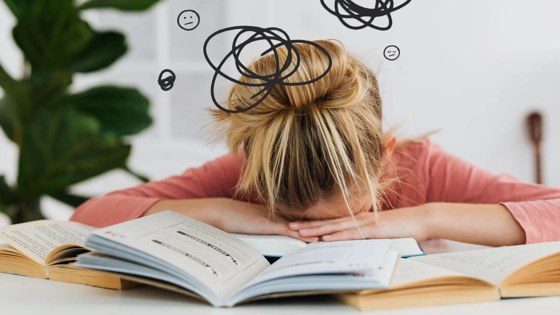 A student with their head face down on a desk covered in books is a part of why Rosemont College is a Forbes rated best online college, and a best Main Line college.