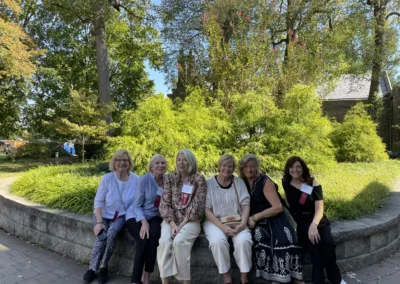 Alumnae seated in front of the Sharon Latchaw Hirsh Community Center to represent how alumni are part of why Rosemont College is a Forbes rated best online college, and a best Main Line college.