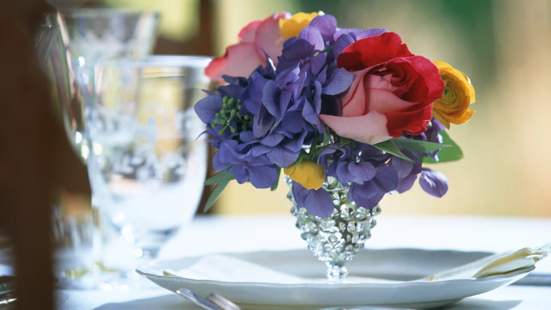 Close up of a floral arrangement and dinner setting to represent how alumni events are part of why Rosemont College is a Forbes rated best online college, and a best Main Line college.
