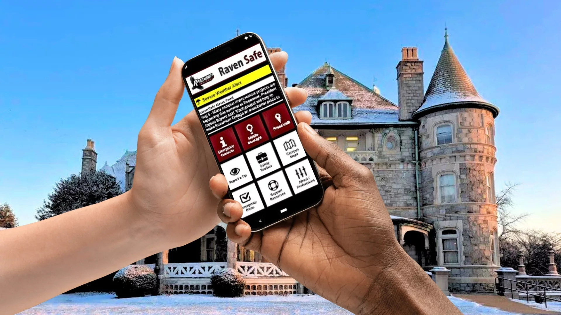 Hands holding a phone displaying the Raven Safe app in front of the main building Rathalla in winter to represent how Rosemont College is a Forbes rated best online college, and a best Main Line college.