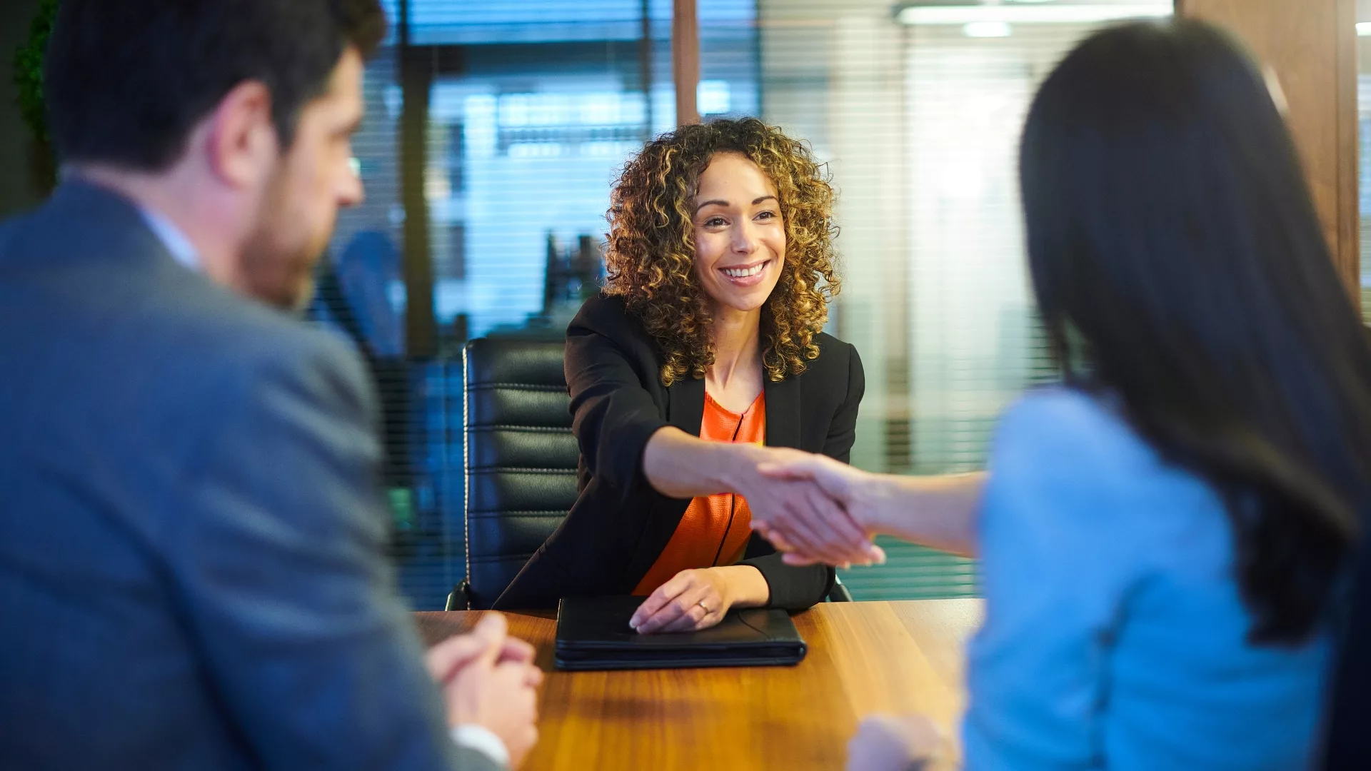 A business woman shaking hands in an interview to represent how internships are part of why Rosemont College is a Forbes rated best online college, and a best Main Line college.