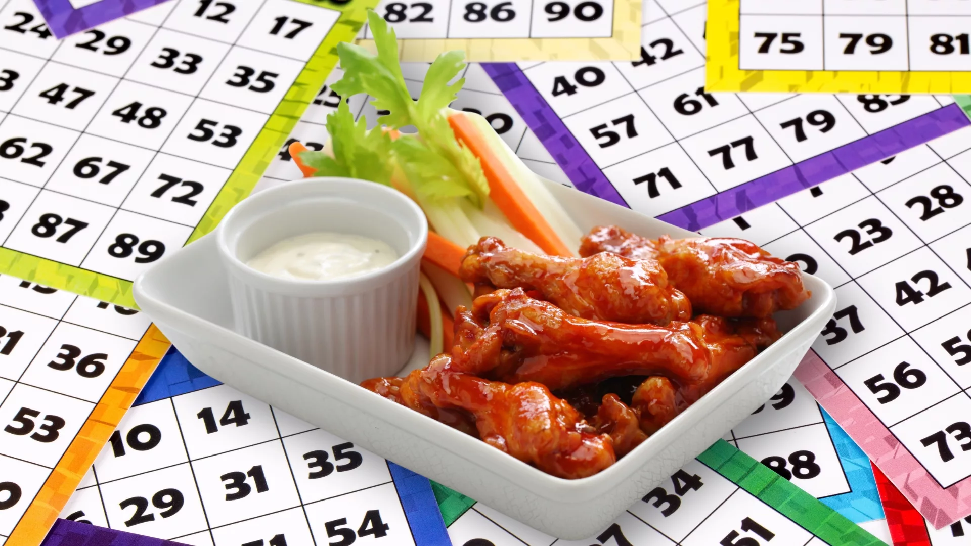 A plate of wings with ranch sauce and veggies overlaid on BINGO cards to represent how Student Engagement events are part of why Rosemont College is a Forbes rated best online college, and a best Main Line college.