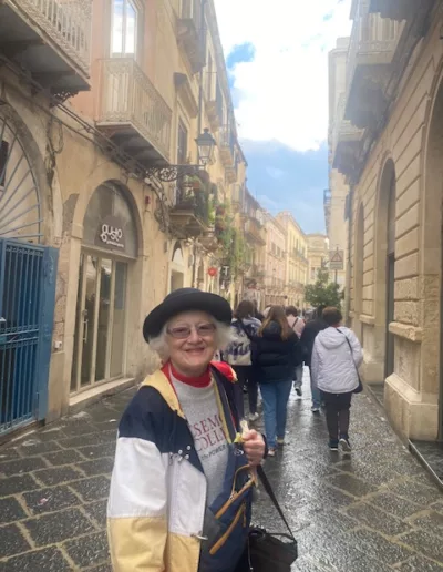 Rosemont College Alumna Linda Romanowski on a Street in Siracusa 2026 is part of why Rosemont College is a Forbes rated best online college, and a best Main Line college.