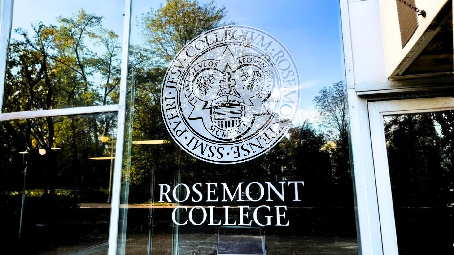 Close up of the seal and logo on the window of Alumnae Hall to represent how campus is part of why Rosemont College is a Forbes rated best online college, and a best Main Line college.