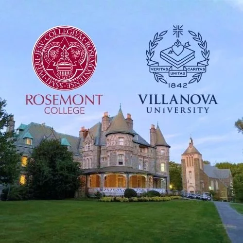 View of the Main Building (Rathalla) ast dusk with the Rosemont College seal and logo on one side of the roof peak and the Villanova University seal and logo on the other side to represent how the planned 2028 merger is part of the Rosemont College legacy to remain a best Main Line college.