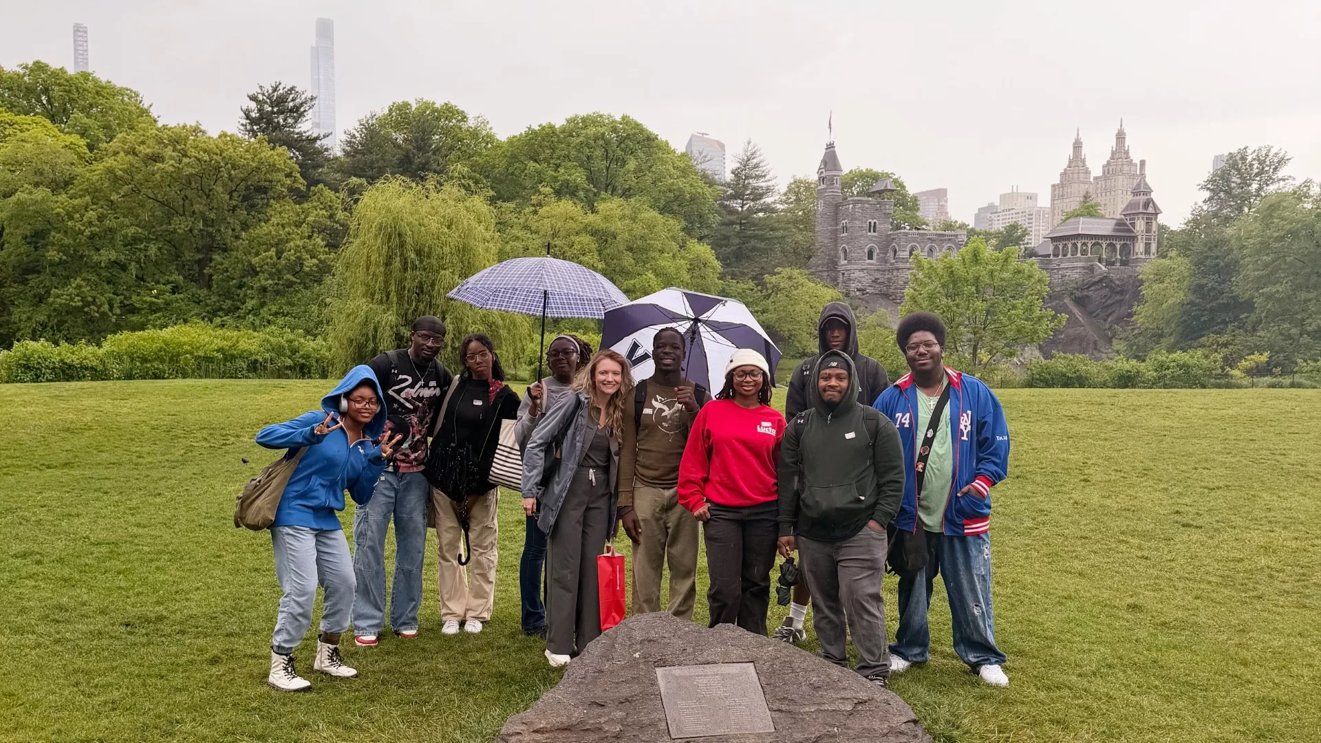 Rosemont College students stand with Professor Joanne Campbell in Central Park with the Central Park West Skyline behind them after visiting The Metropolitan Museum of Art is part of why Rosemont College is a Forbes rated best online college, and a best Main Line college.
