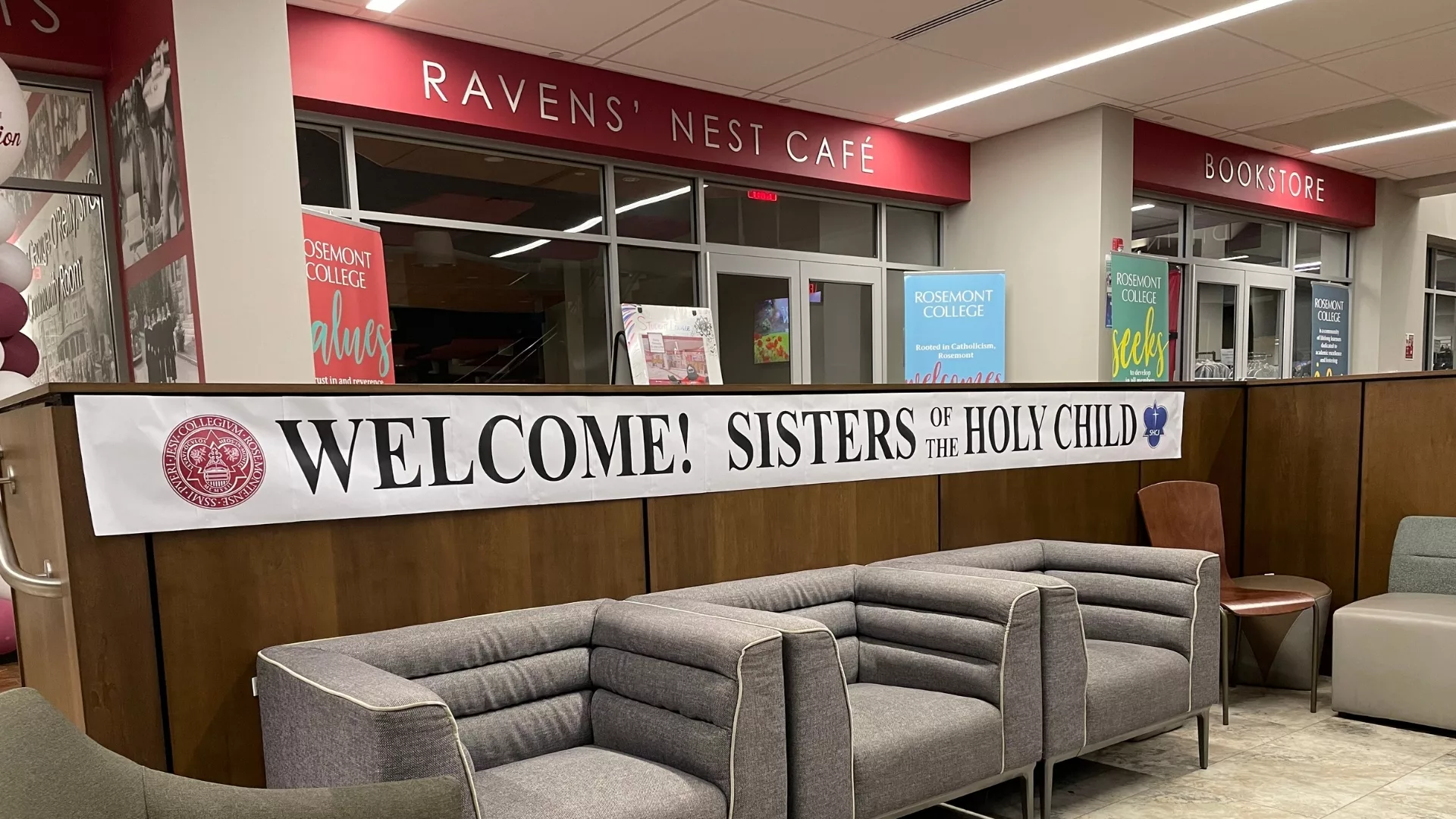 A banner welcoming the Sisters of the Holy Child Jesus in front of the Ravens Nest Cafe to represent how campus is a part of why Rosemont College is a Forbes rated best online college, and a best Main Line college.