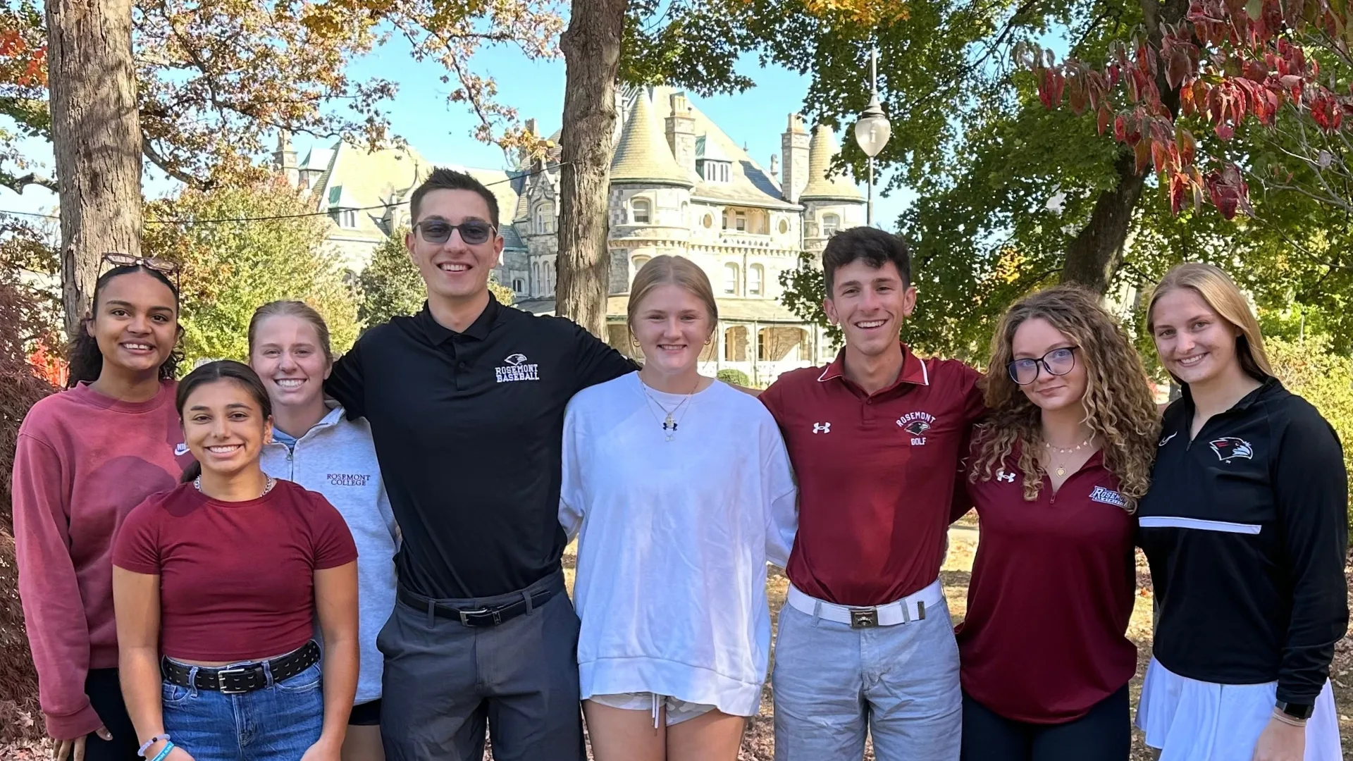Rosemont College Students Students on campus in autumn with the main building Rathalla in the distance to represent how Rosemont College is a Forbes rated best online college, and a best Main Line college.
